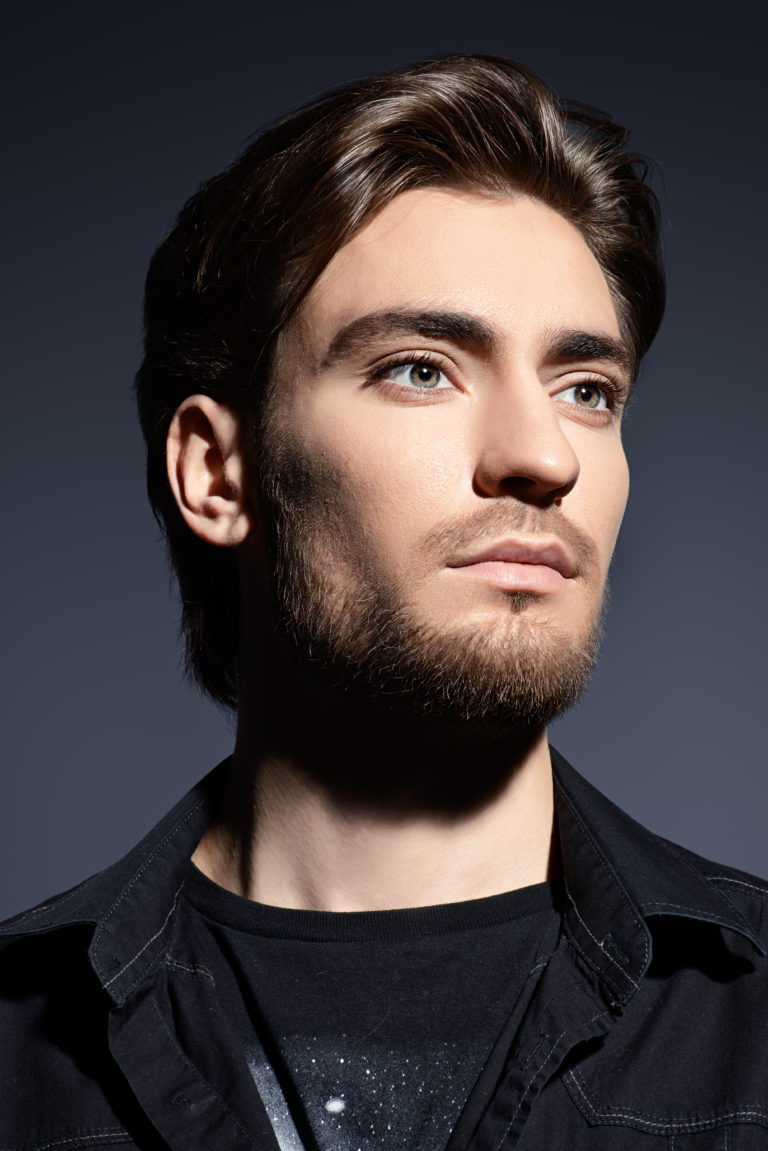 Portrait of a handsome young man. Men's beauty, fashion. Hairstyle.