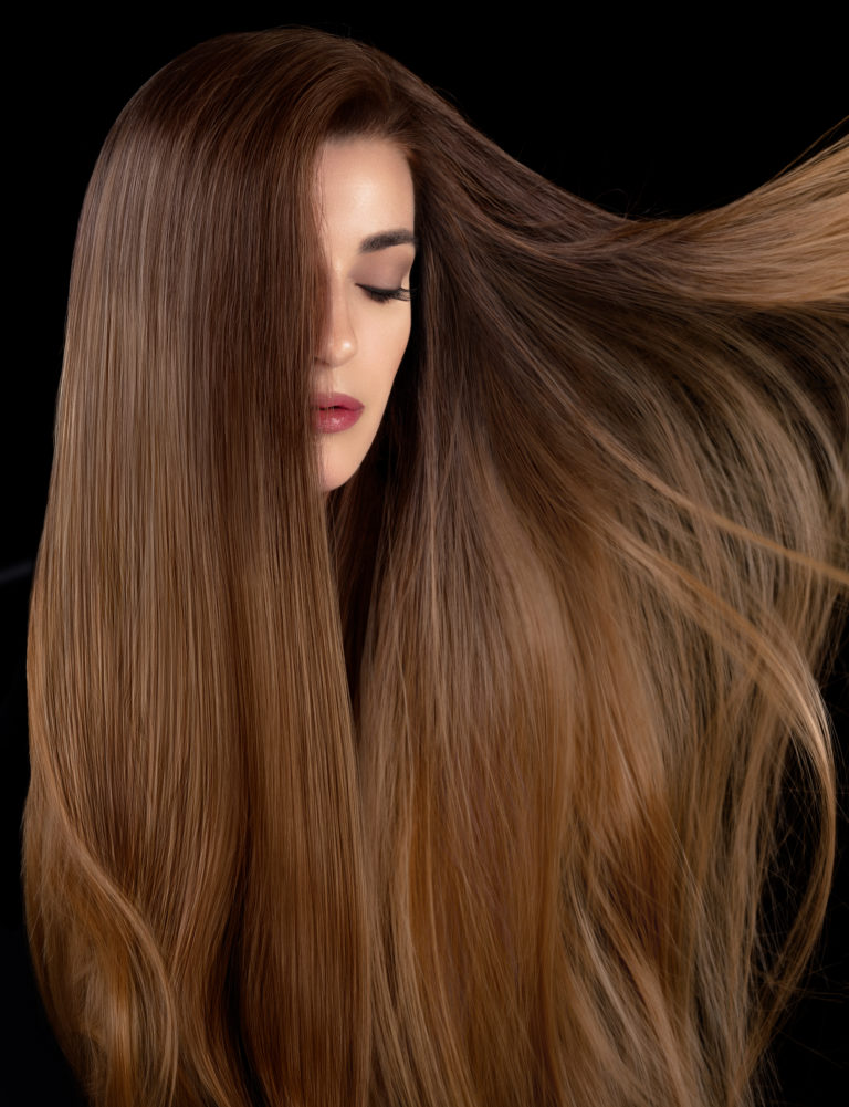 Healthy long hair. Beautiful model girl with shiny smooth and straight long hair. Hair care and keratin straightening, smoothing and treatment.